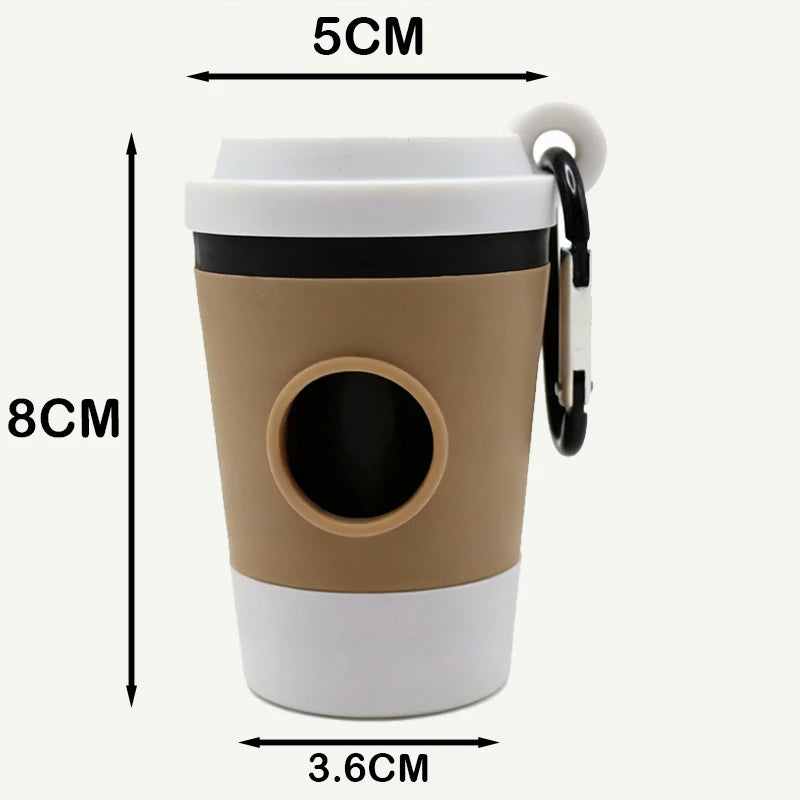 Coffee-cup poop bag holder with white lid, tan sleeve, bag hole and carabiner, about 8 cm tall and 5 cm wide