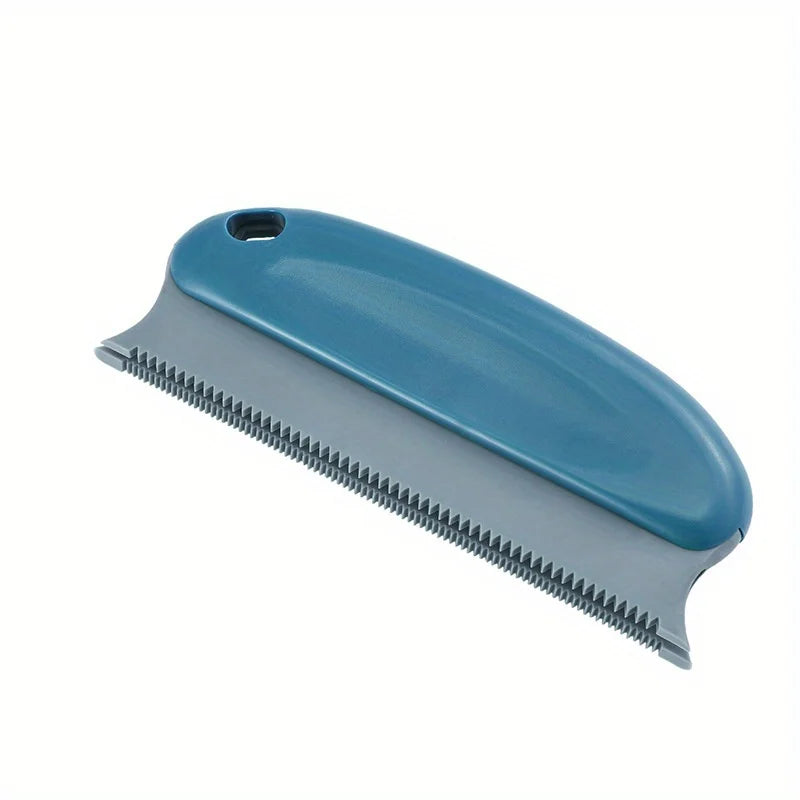 Handheld pet hair scraper brush pulling a pile of dog fur out of a carpet