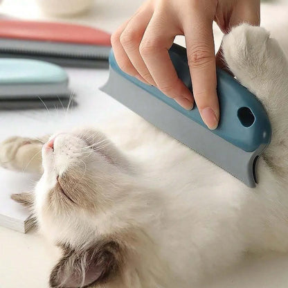 Handheld pet hair scraper brush pulling a pile of dog fur out of a carpet