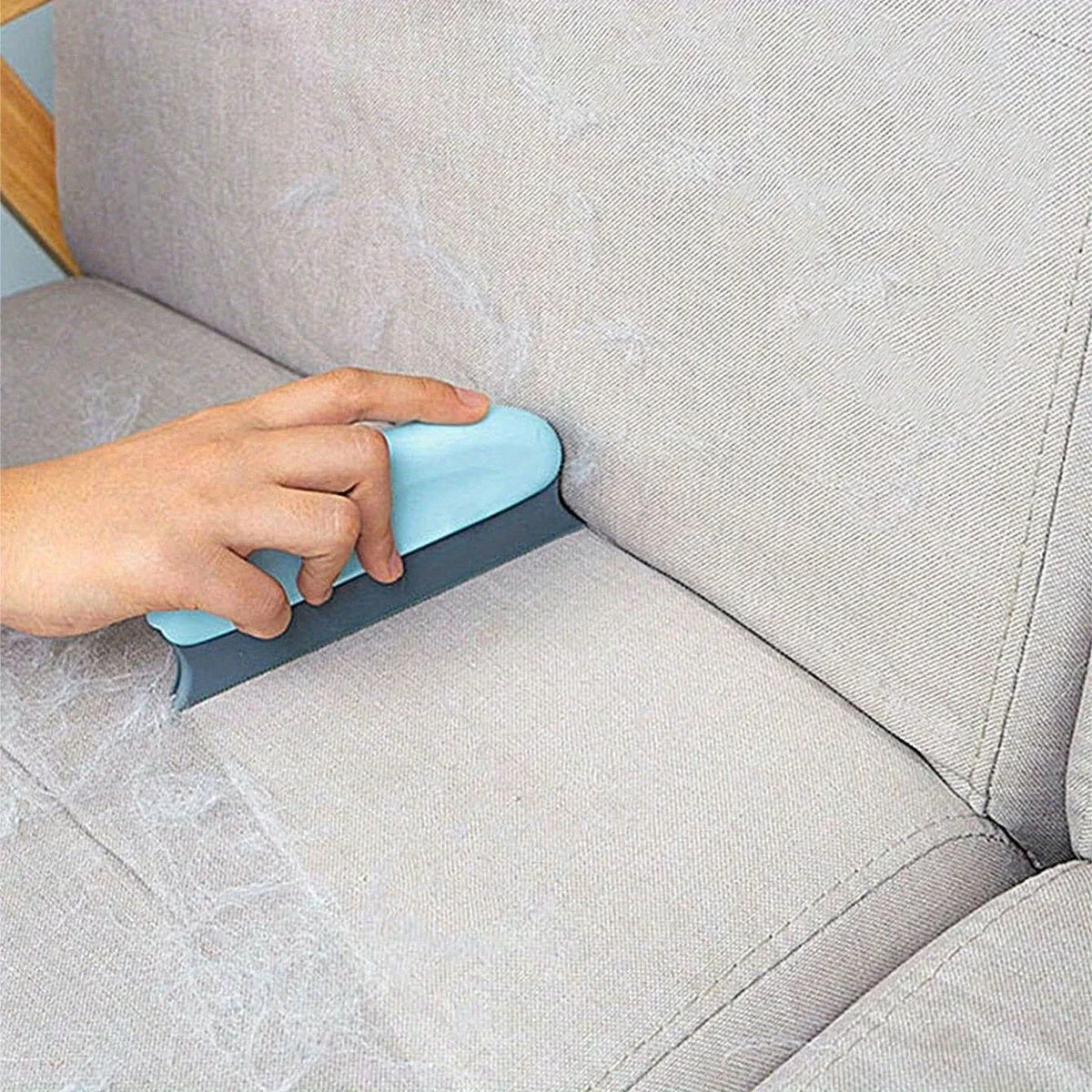 Pet hair scraper brush on a couch