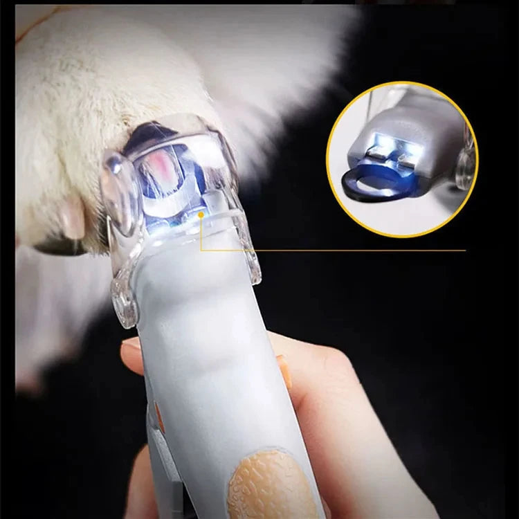 LED light shining through a pet's nail inside the clear clipper cover