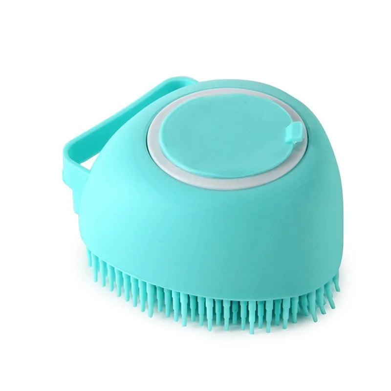 Blue heart-shaped silicone dog bath brush with a refillable shampoo chamber and hand strap