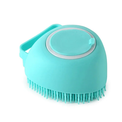 Blue heart-shaped silicone dog bath brush with a refillable shampoo chamber and hand strap