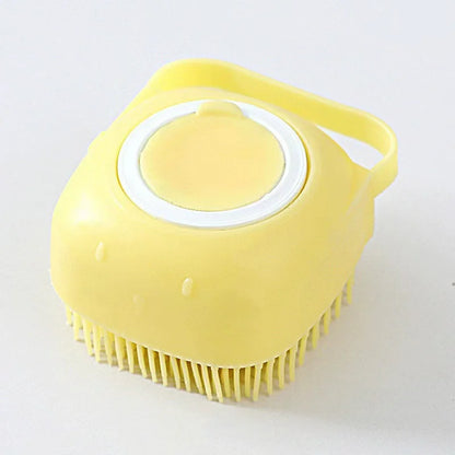 Yellow square silicone dog bath brush with a refillable shampoo chamber and hand strap