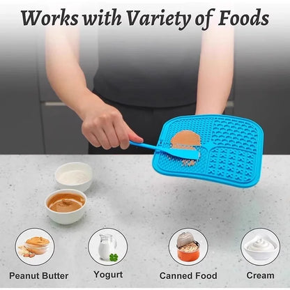 Spreading soft food onto a blue silicone lick mat