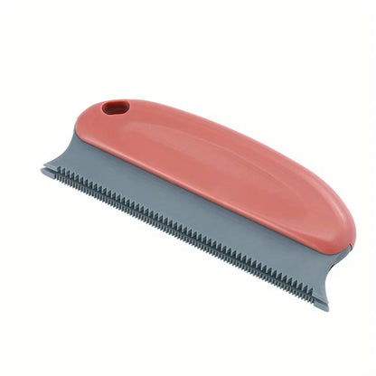 Handheld pet hair scraper brush pulling a pile of dog fur out of a carpet