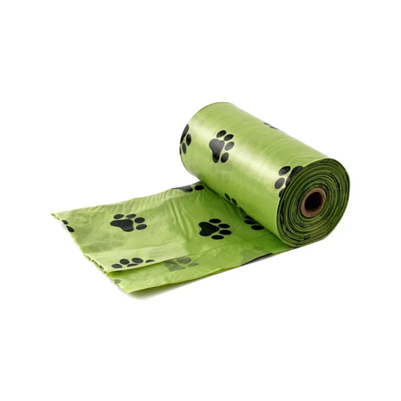 Roll of green dog poop bags with a paw print pattern