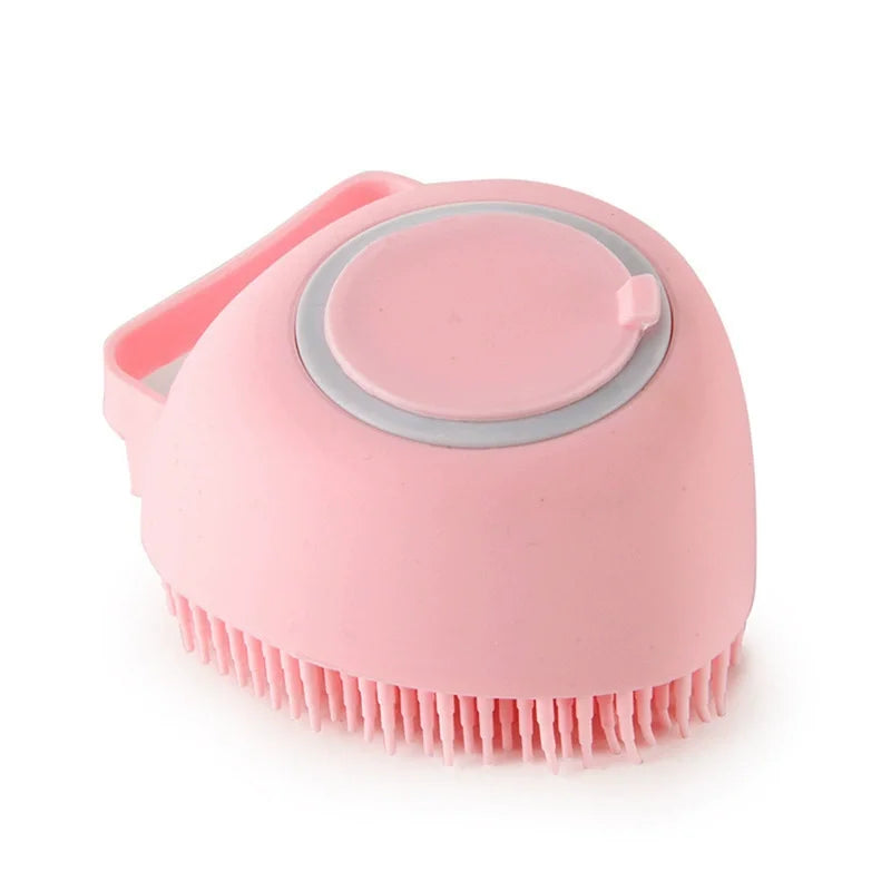 Pink heart-shaped silicone dog bath brush with a refillable shampoo chamber and hand strap